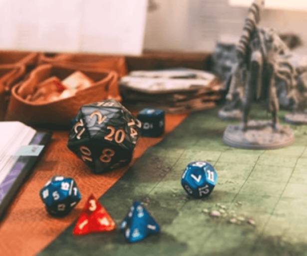 A scene of dice and minifigs across a table, set up and ready to be used for a game.